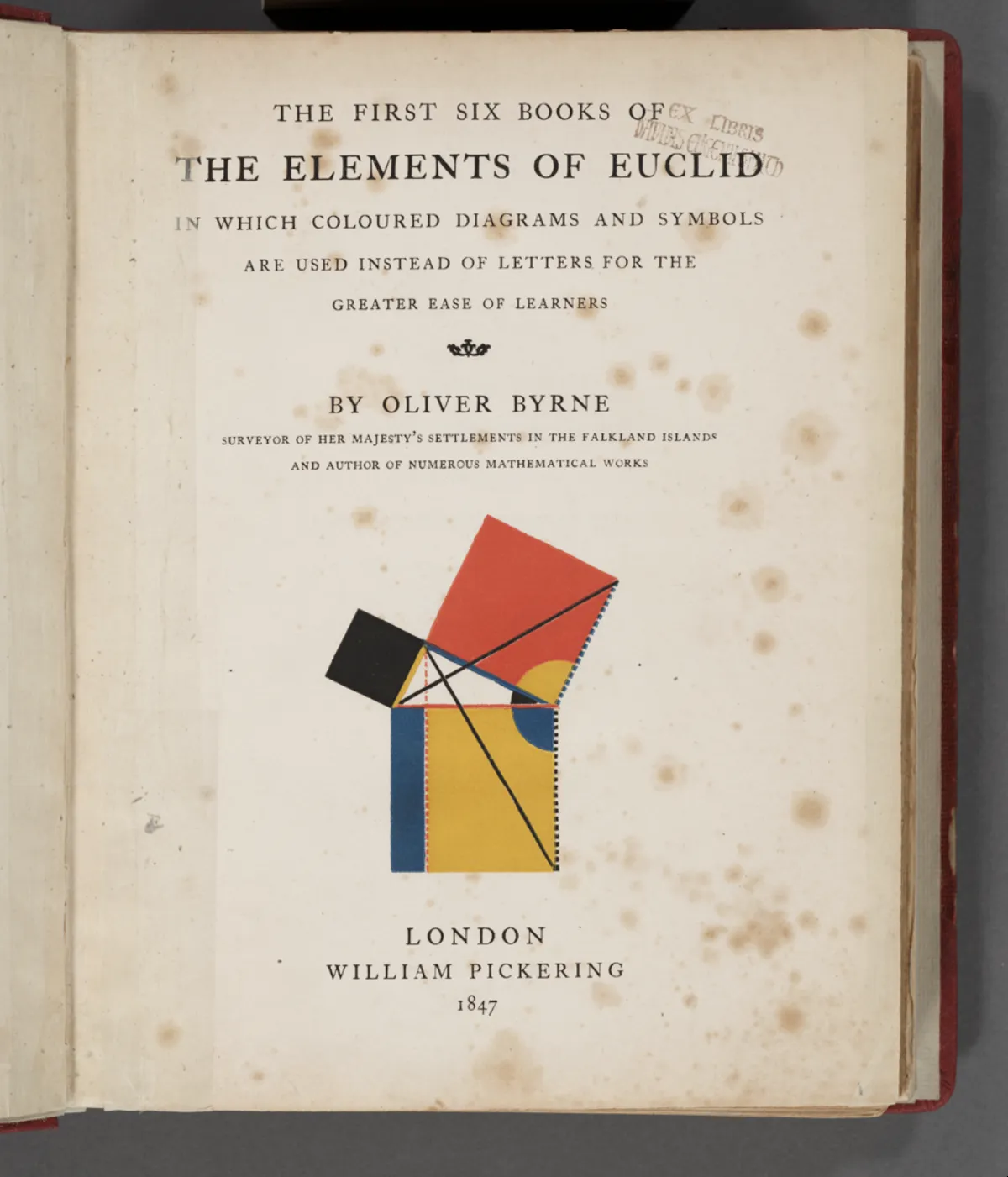 An 1847 title page, foxed and cream-coloured, in an open red-bound book, with a coloured red, yellow, blue and black geometric figure printed below the lettering.