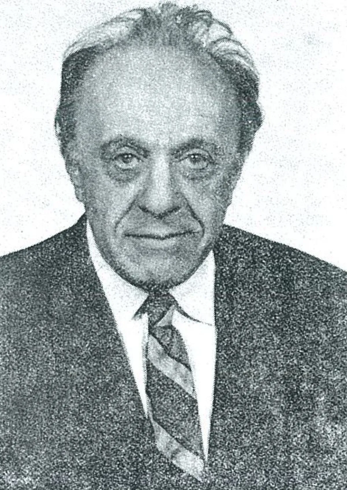 A coarse black and white halftone photograph of an older man with swept-back wavy hair, in a dark suit, white shirt and striped tie, facing the camera.