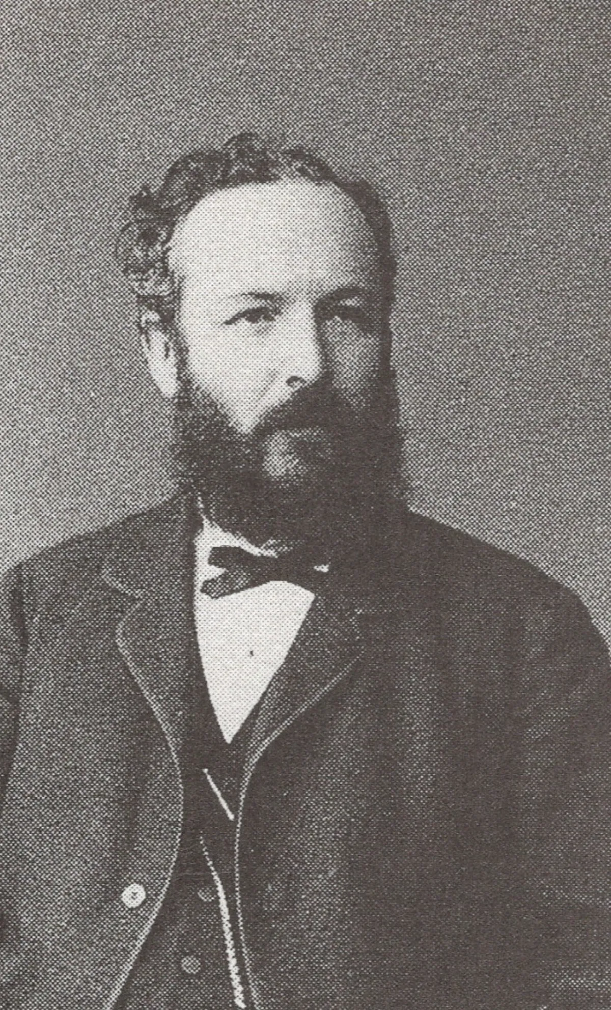 A nineteenth-century visiting-card studio portrait of a bearded man in dark formal dress, shown from the chest up.