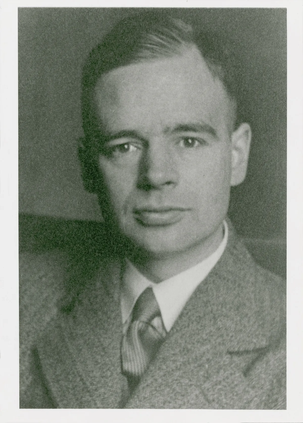 Black-and-white studio portrait photograph of a young man, head and shoulders, facing the camera.